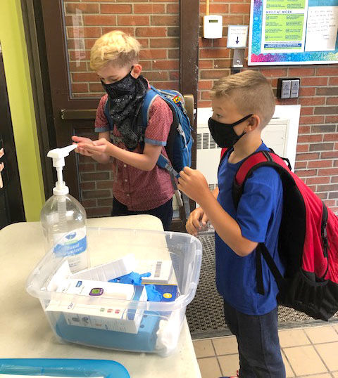 Students sanitizing hands